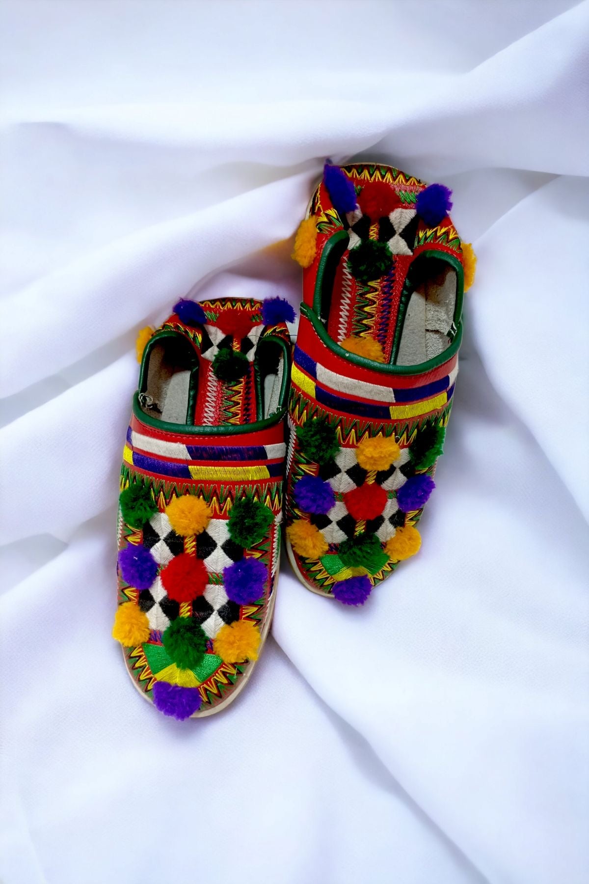 Embroidered Moroccan slippers with decorative pom-poms